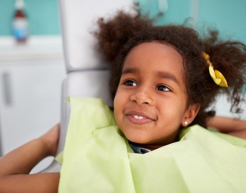 Little girl smiling during dental checkup and teeth cleaning visit