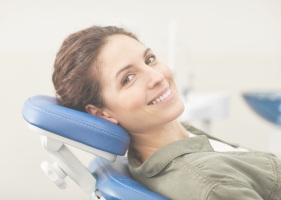 Smiling woman in dental chair for preventive dentistry