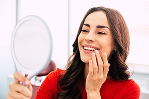 A woman admiring her newly-restored smile