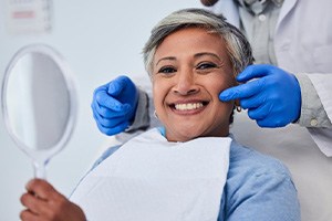 A woman admiring her newly-restored smile